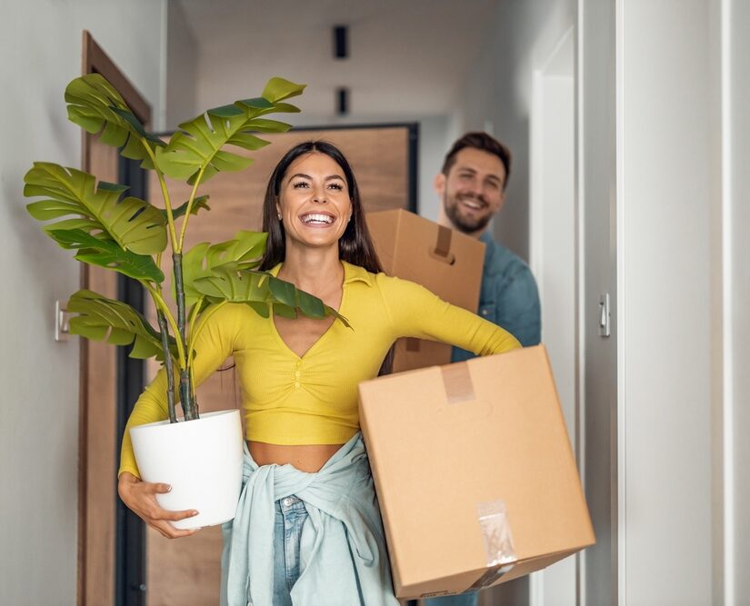 Young,Couple,Moving,In,New,Home.couple,Is,Having,Fun,With